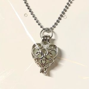Bundle 3 for $30. Silver hollow heart pendant. Glows in ice blue or aqua green.